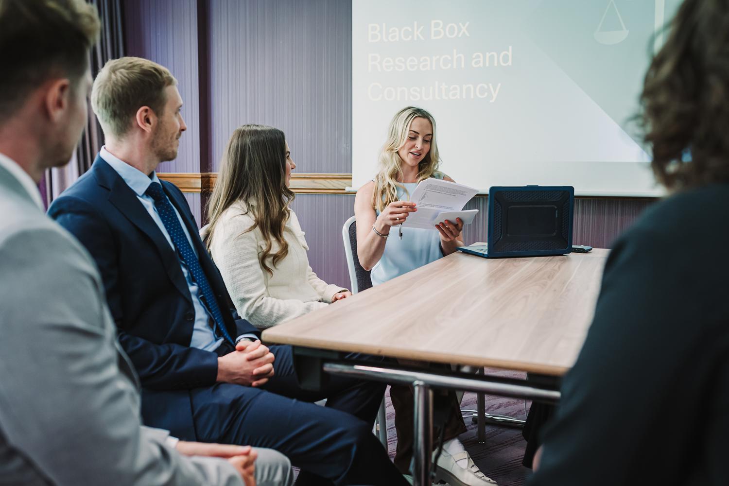 Director leading a group discussion during a workshop at Black Box Research & Consultancy.